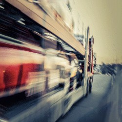Cars being transported in trucks